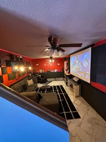 a room with furniture projector and screen