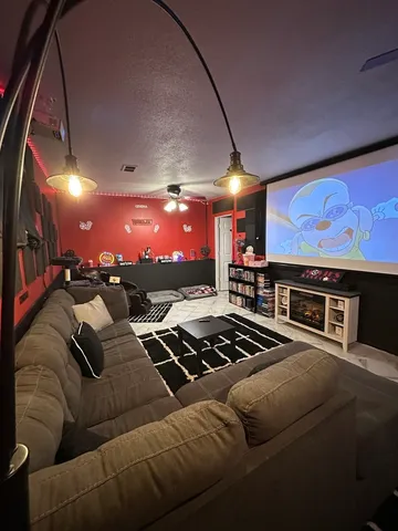 a view of a living room with furniture and a flat screen tv