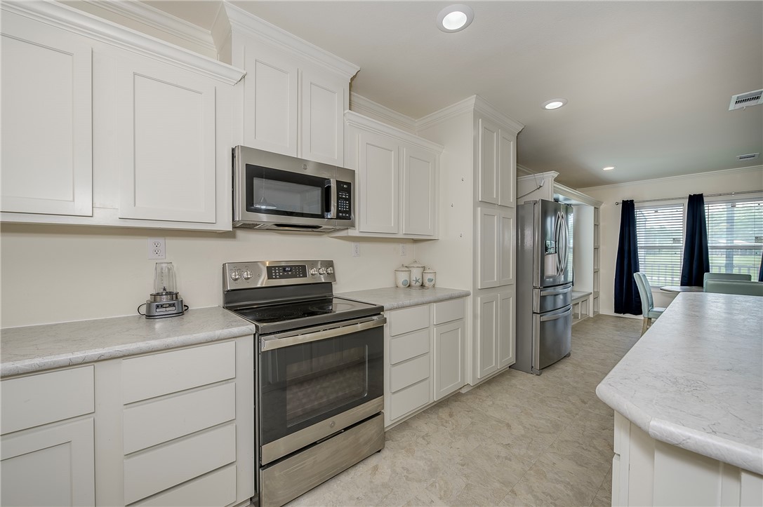 10976 Whiterock Road Bremond, TX 76629 - Photo 10 of 42 a kitchen with a sink stove and refrigerator