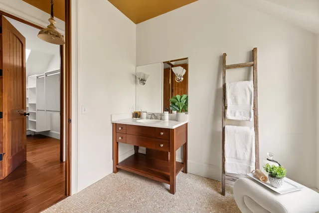 a bathroom with a sink a mirror and a window