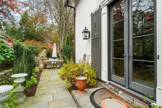 a view of a porch with chairs potted plants