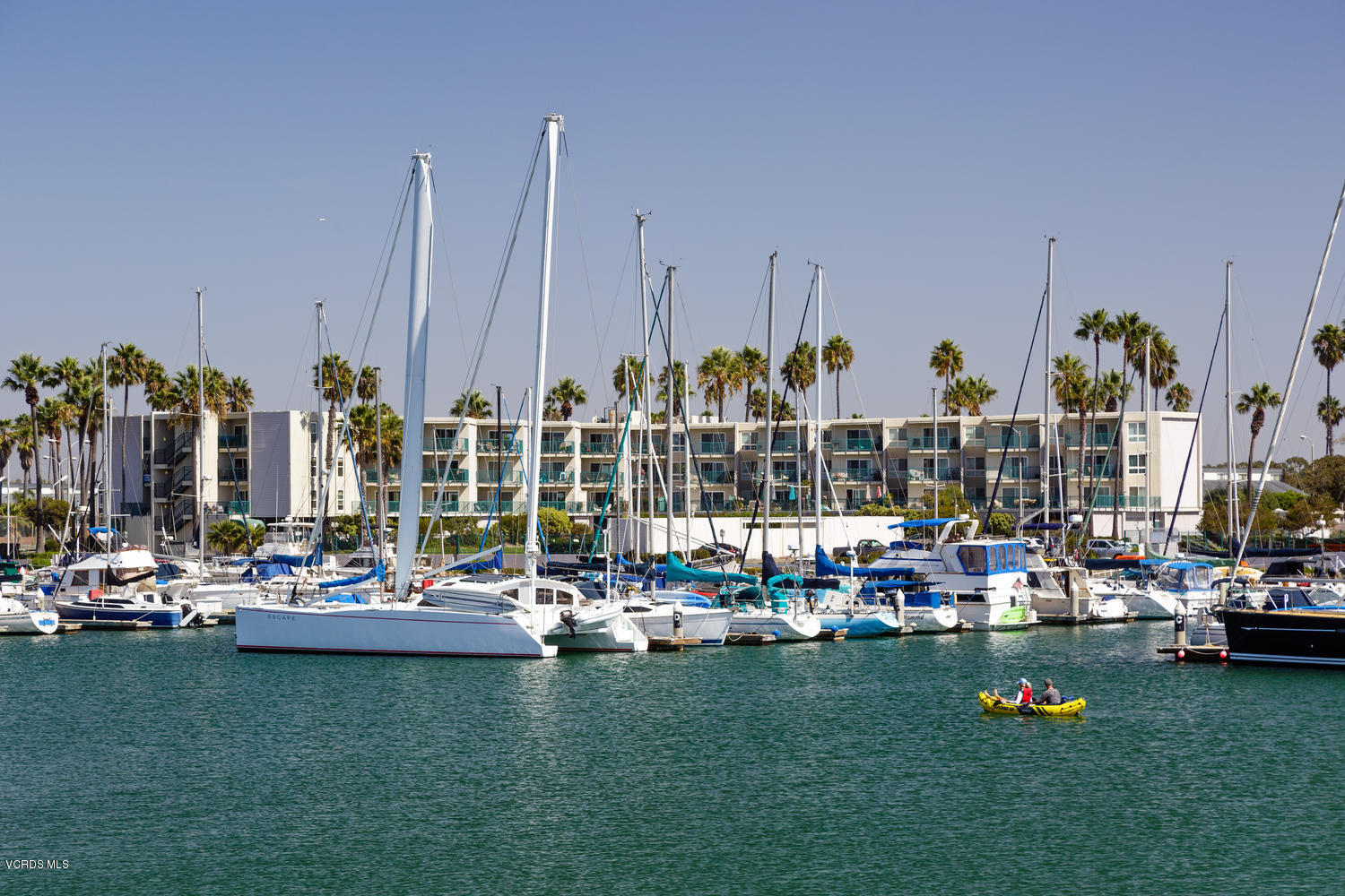 3101 Peninsula Road, Unit 104 Oxnard, CA 93035 - Photo 11 of 29 a view of a lake with boats and palm trees