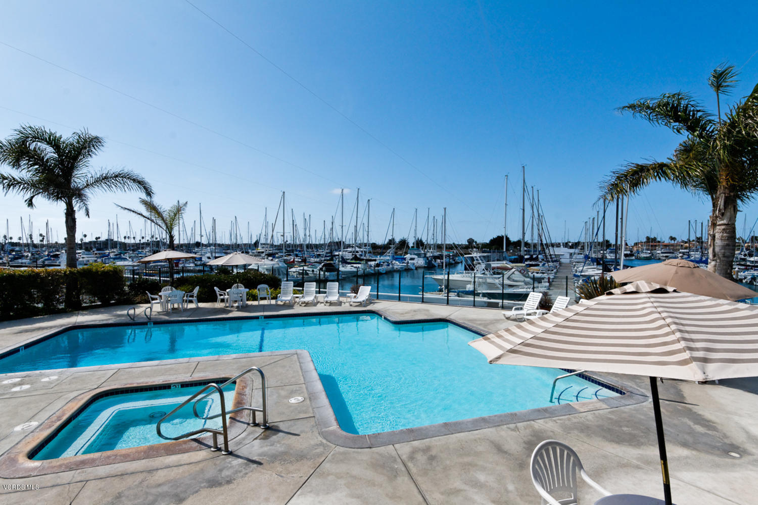 3101 Peninsula Road, Unit 104 Oxnard, CA 93035 - Photo 18 of 29 a view of a swimming pool and lounge chair