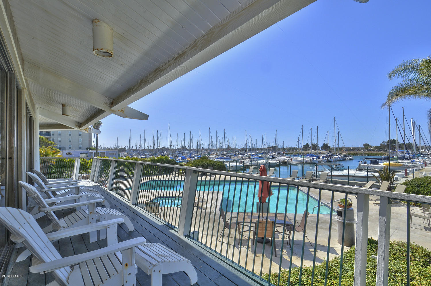 3101 Peninsula Road, Unit 104 Oxnard, CA 93035 - Photo 19 of 29 a view of a balcony with wooden floor and outdoor seating