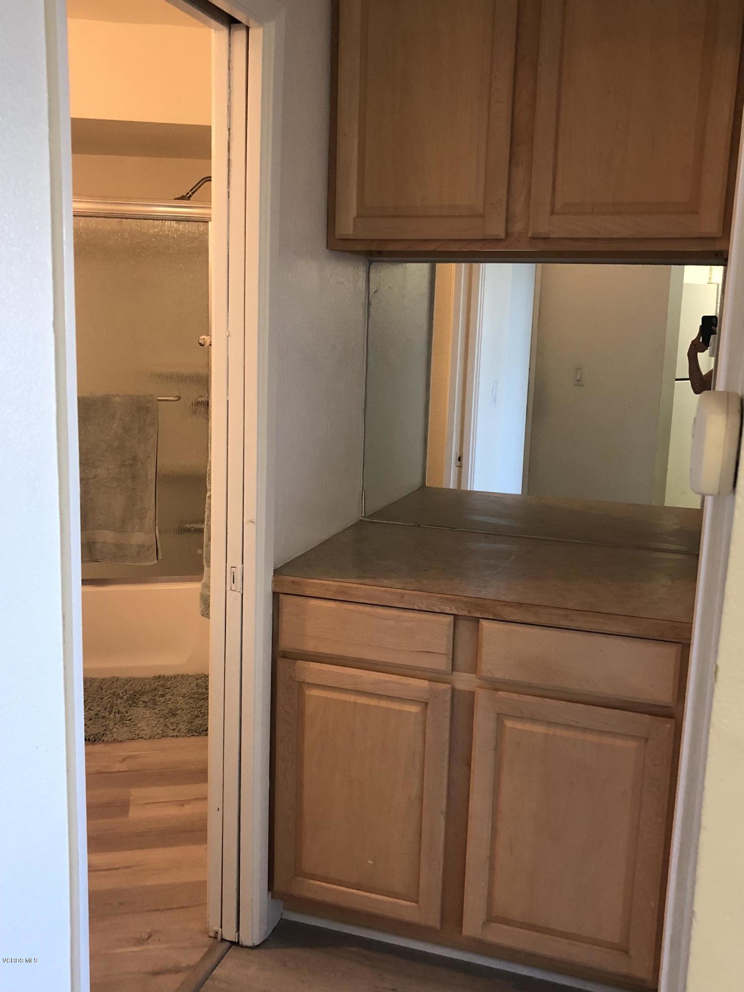 3101 Peninsula Road, Unit 104 Oxnard, CA 93035 - Photo 7 of 29 a kitchen with a white cabinets and a sink