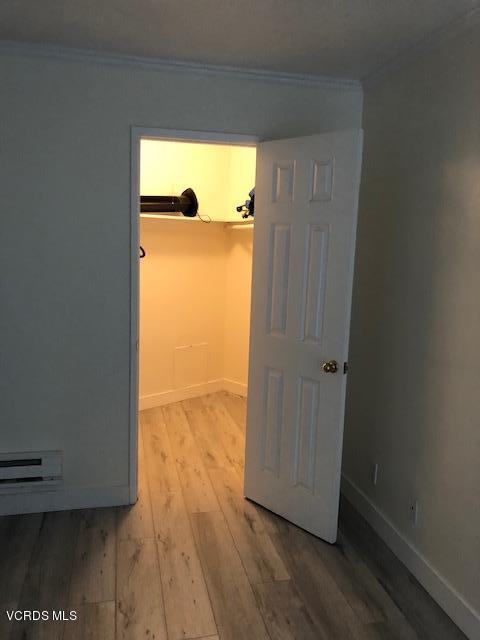 3101 Peninsula Road, Unit 104 Oxnard, CA 93035 - Photo 9 of 29 an empty room with wooden floor and windows