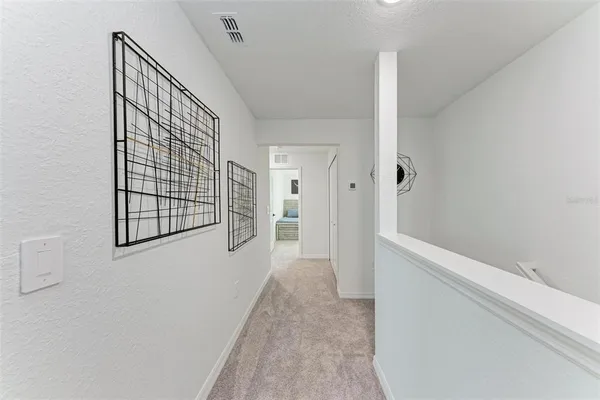 a view of a hallway with wooden floor and entryway