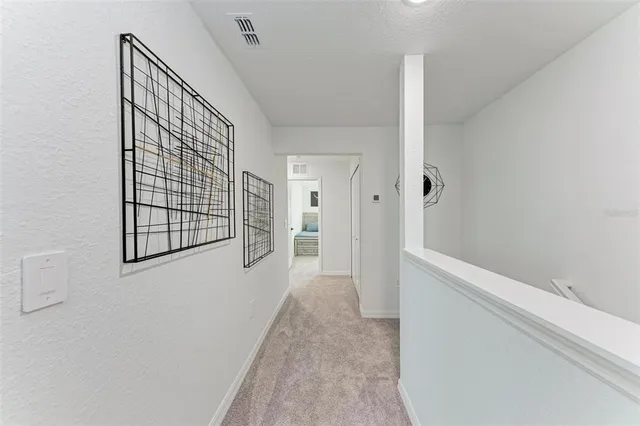 a view of a hallway with wooden floor and entryway