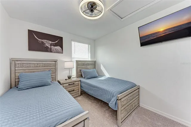 a bedroom with a bed and a chandelier