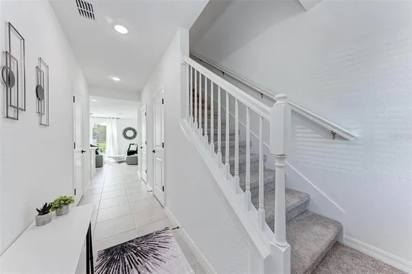 a view of entryway and hall with wooden floor
