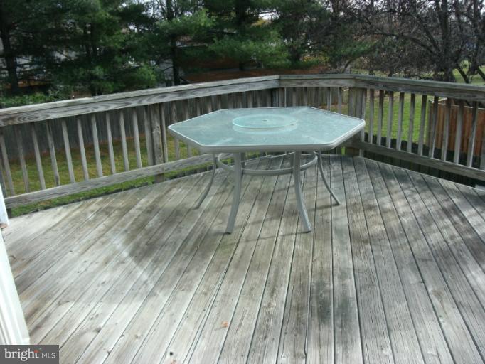 17635 Kohlhoss Road Poolesville, MD 20837 - Photo 4 of 14 a view of a wooden deck with a table and chairs