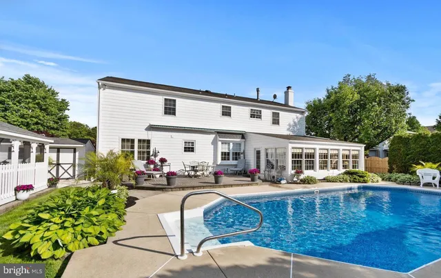 a view of a house with swimming pool and sitting area
