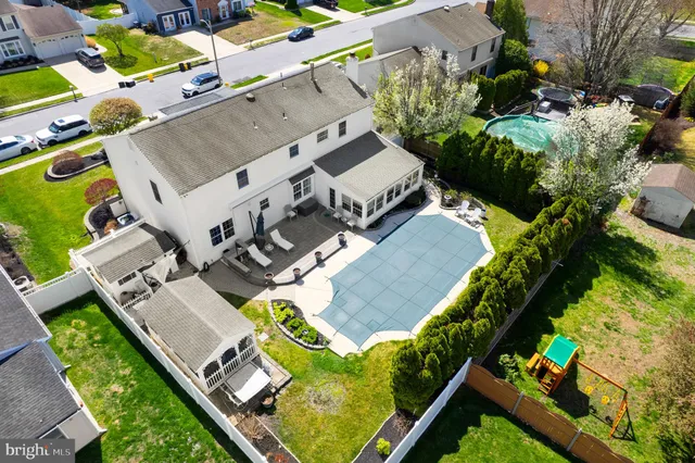an aerial view of a house with a garden and houses