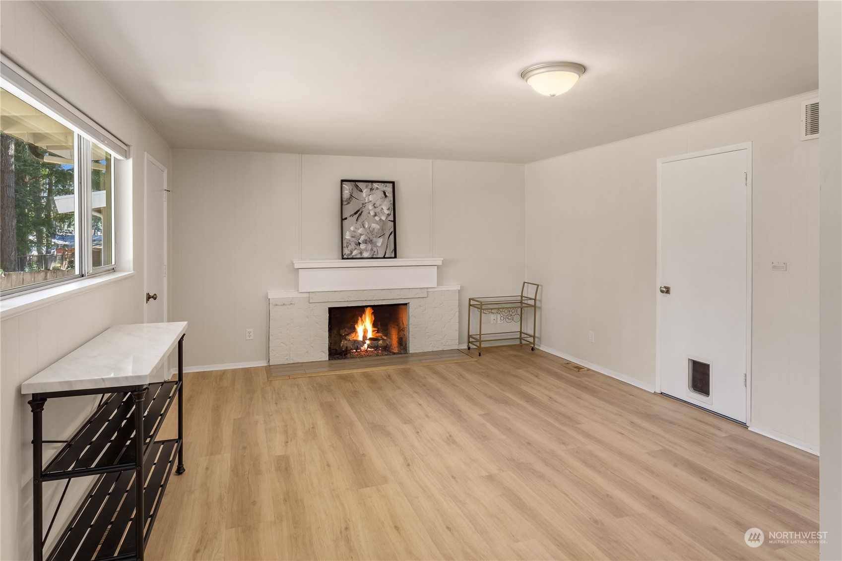 4418 Northeast 18th Court Renton, WA 98059 - Photo 11 of 22 a view of an empty room with window and fire place