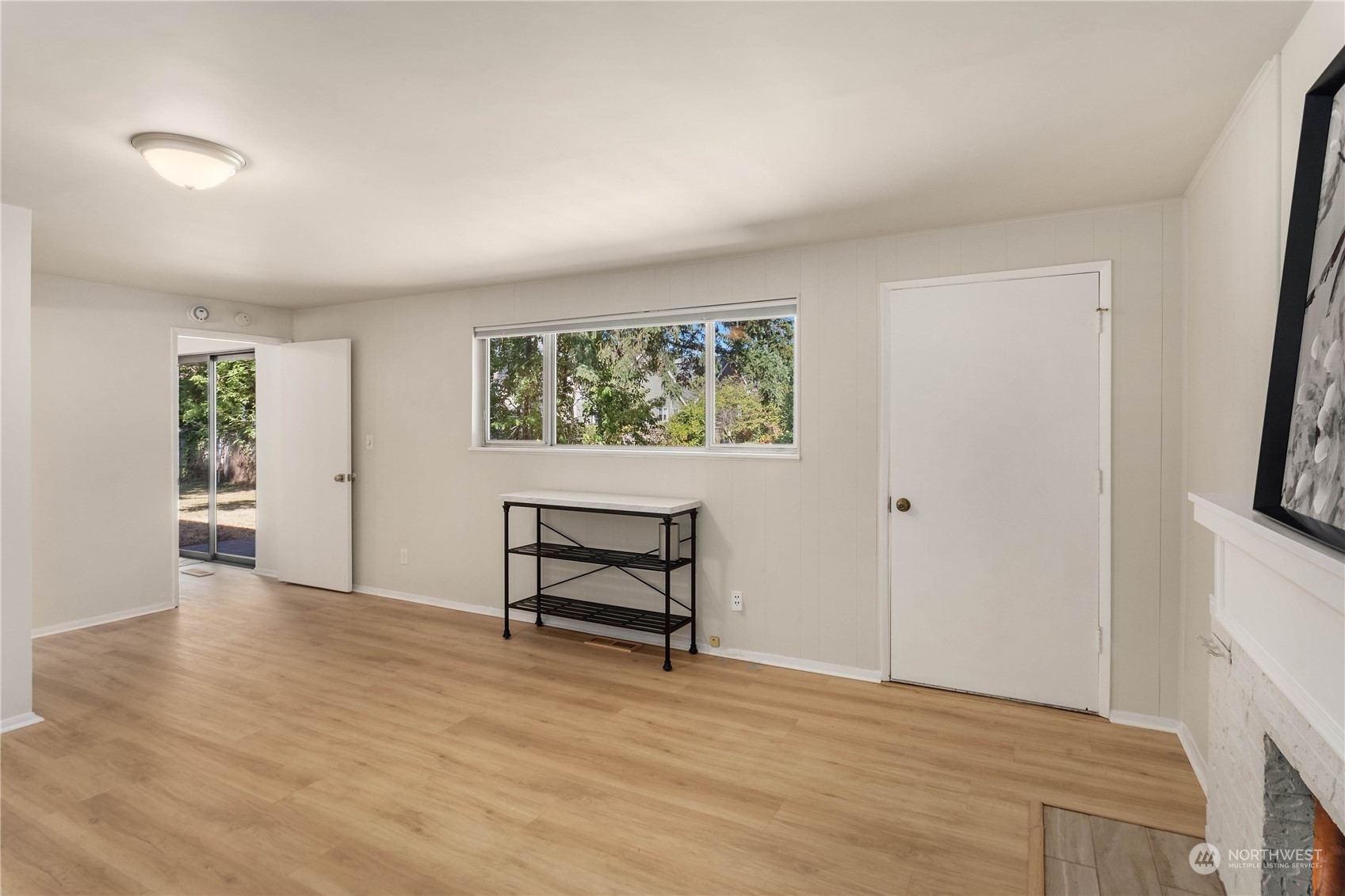 4418 Northeast 18th Court Renton, WA 98059 - Photo 13 of 22 a view of an empty room with window and wooden floor