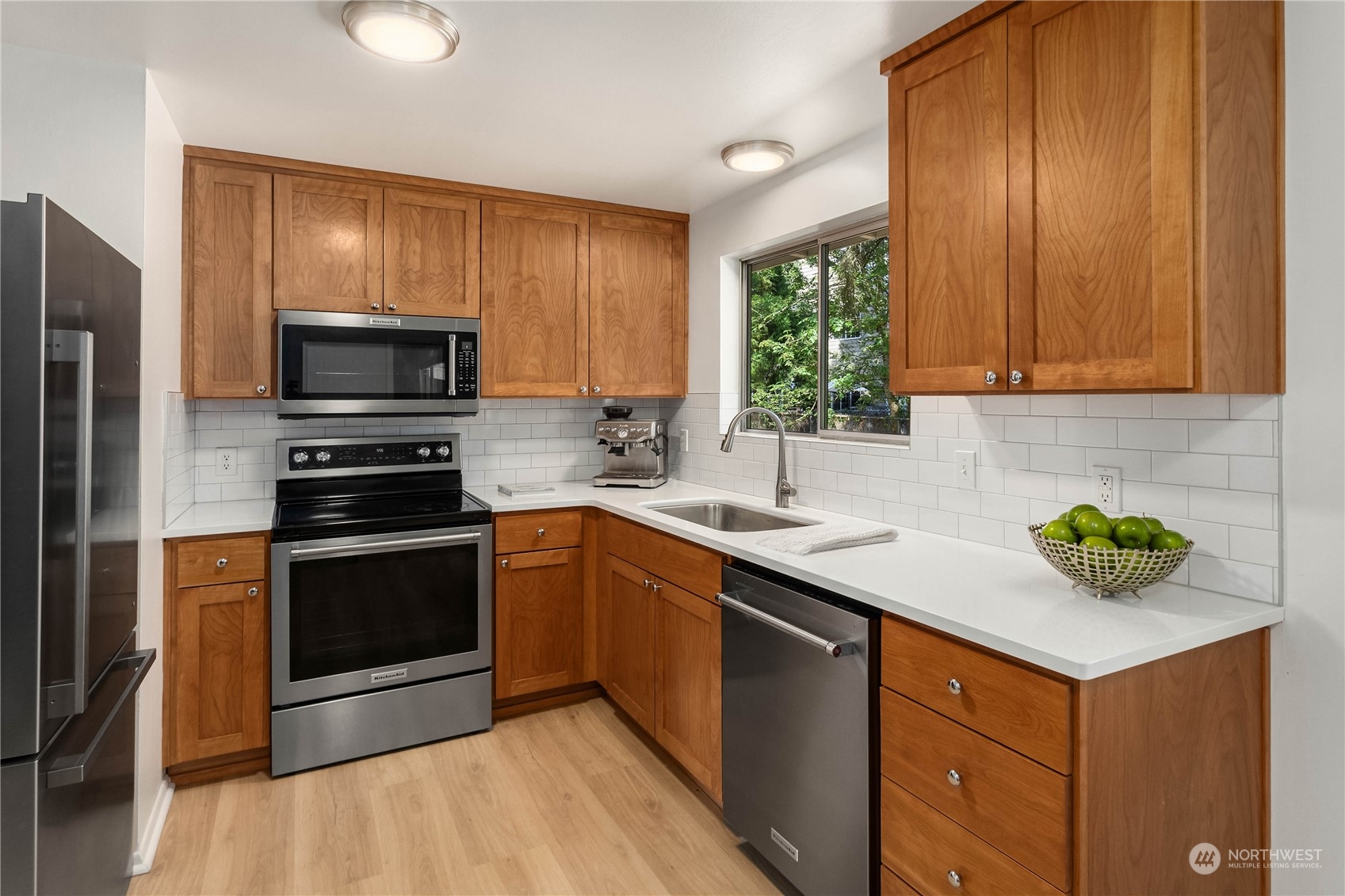 4418 Northeast 18th Court Renton, WA 98059 - Photo 6 of 22 a kitchen with a sink cabinets stainless steel appliances and a window
