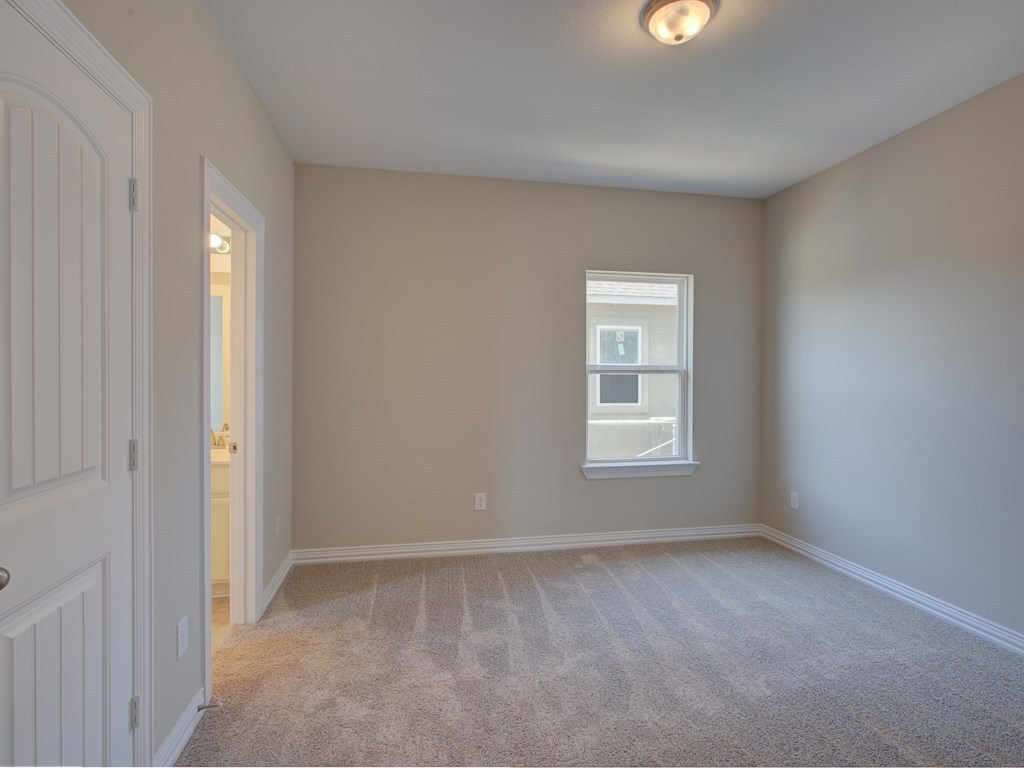 4303 Logan Ridge Drive Cedar Park, TX 78613 - Photo 18 of 24 Carpeted room featuring a white-framed window, flush-mount ceiling light fixture, and a paneled interior door