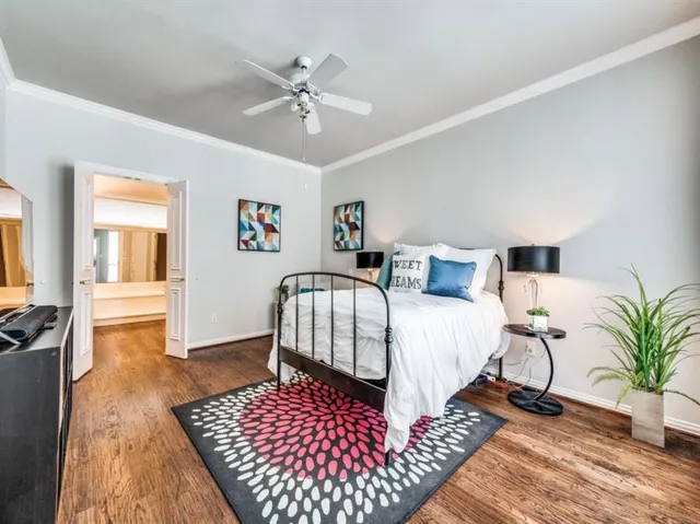 a bedroom with bed and wooden floor