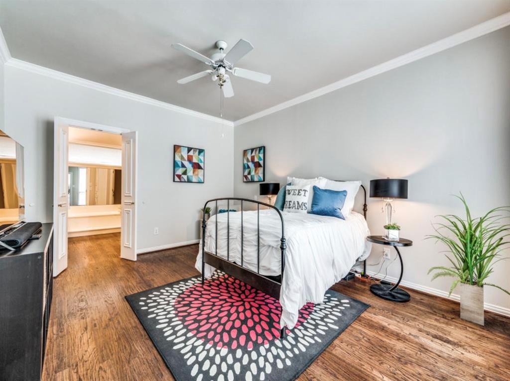 4007 Kirkmeadow Lane Dallas, TX 75287 - Photo 11 of 18 a bedroom with bed and wooden floor