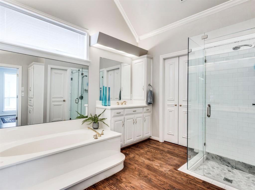 4007 Kirkmeadow Lane Dallas, TX 75287 - Photo 14 of 18 a spacious bathroom with a tub shower and sink