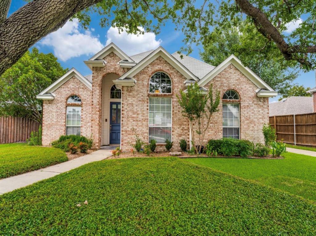 4007 Kirkmeadow Lane Dallas, TX 75287 - Photo 18 of 18 a front view of a house with a yard and garage