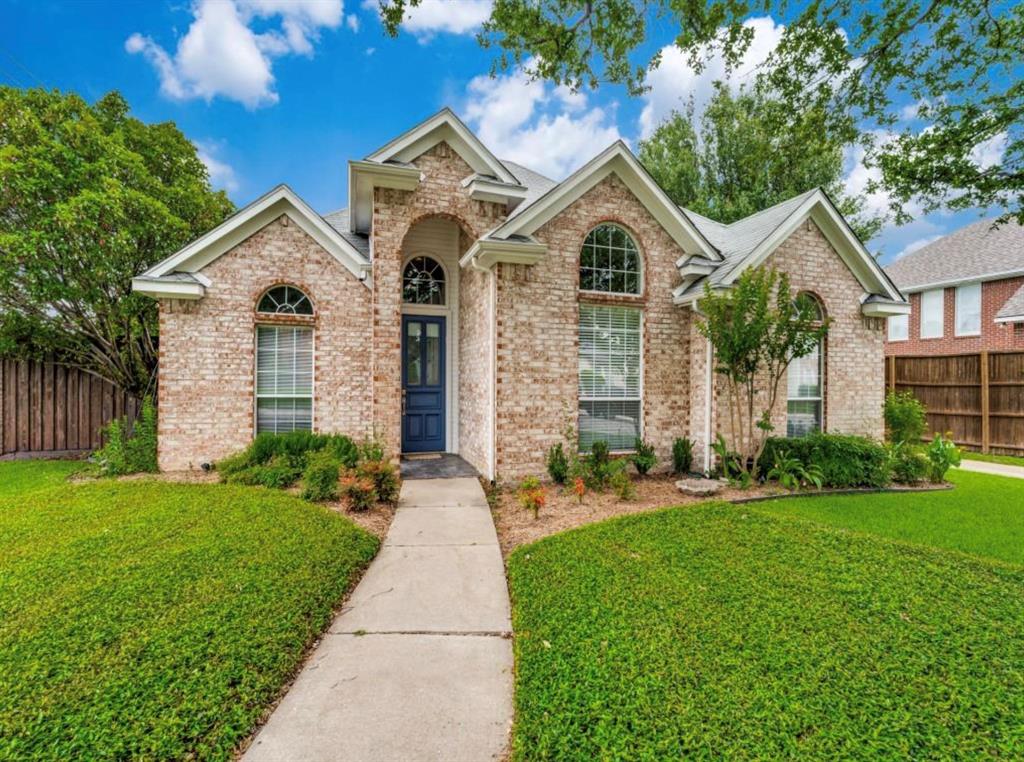 4007 Kirkmeadow Lane Dallas, TX 75287 - Photo 2 of 18 a view of a brick house with a yard and potted plants