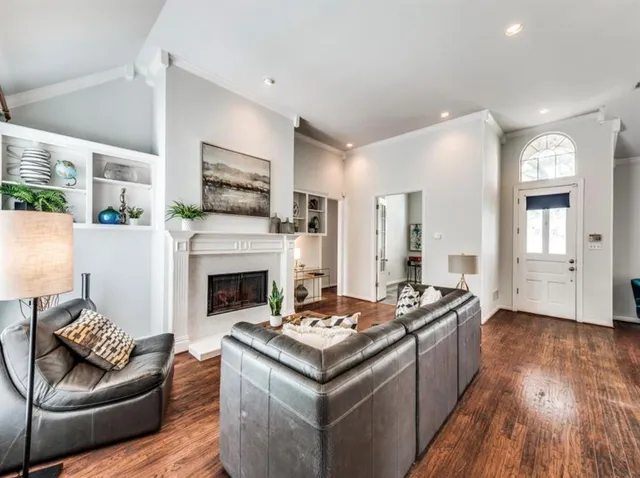 a living room with furniture and a fireplace