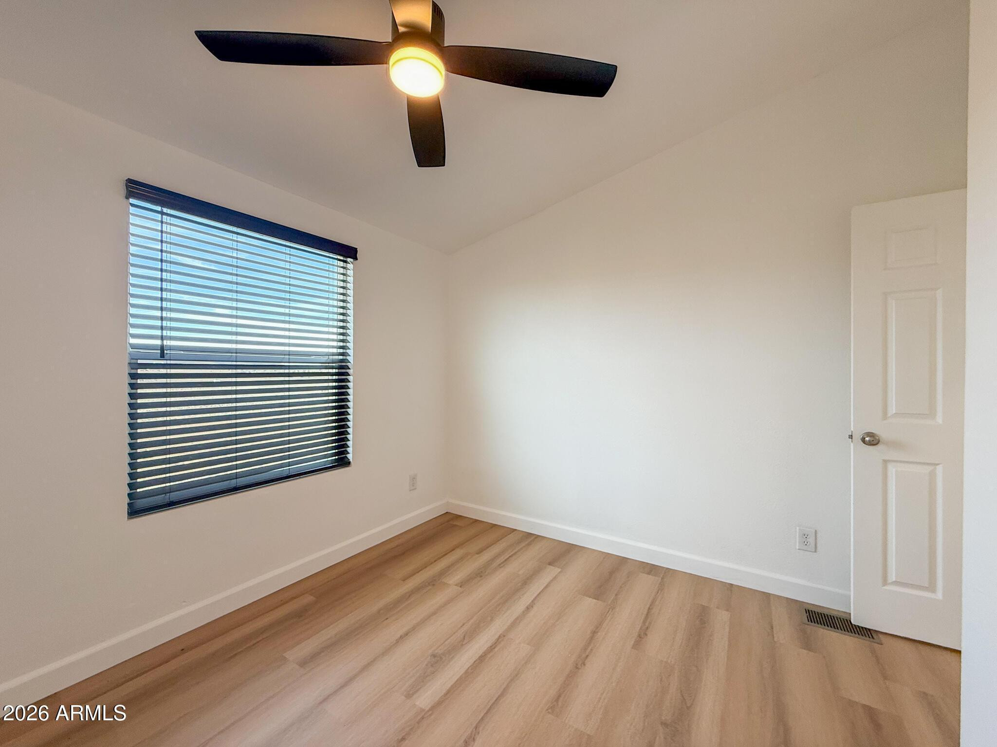 51880 North Gold Plains Road Seligman, AZ 86337 - Photo 17 of 24 an empty room with a window and a ceiling fan