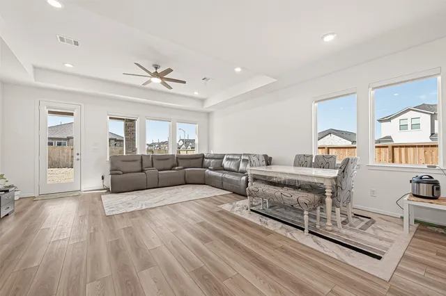 a living room with furniture and a wooden floor