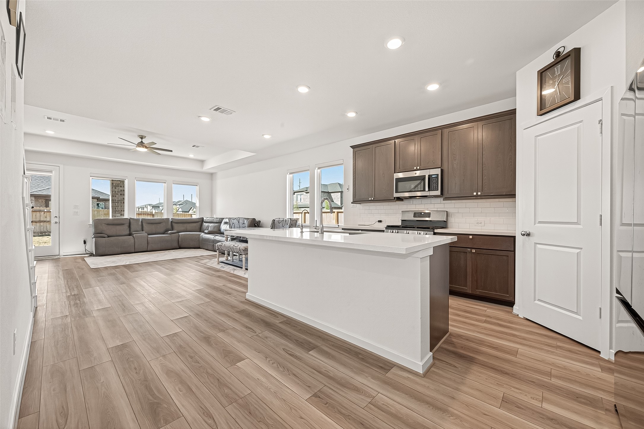 9747 Pettus Crk Drive Cypress, TX 77433 - Photo 17 of 48 a kitchen with stainless steel appliances granite countertop a stove top oven a sink and a refrigerator