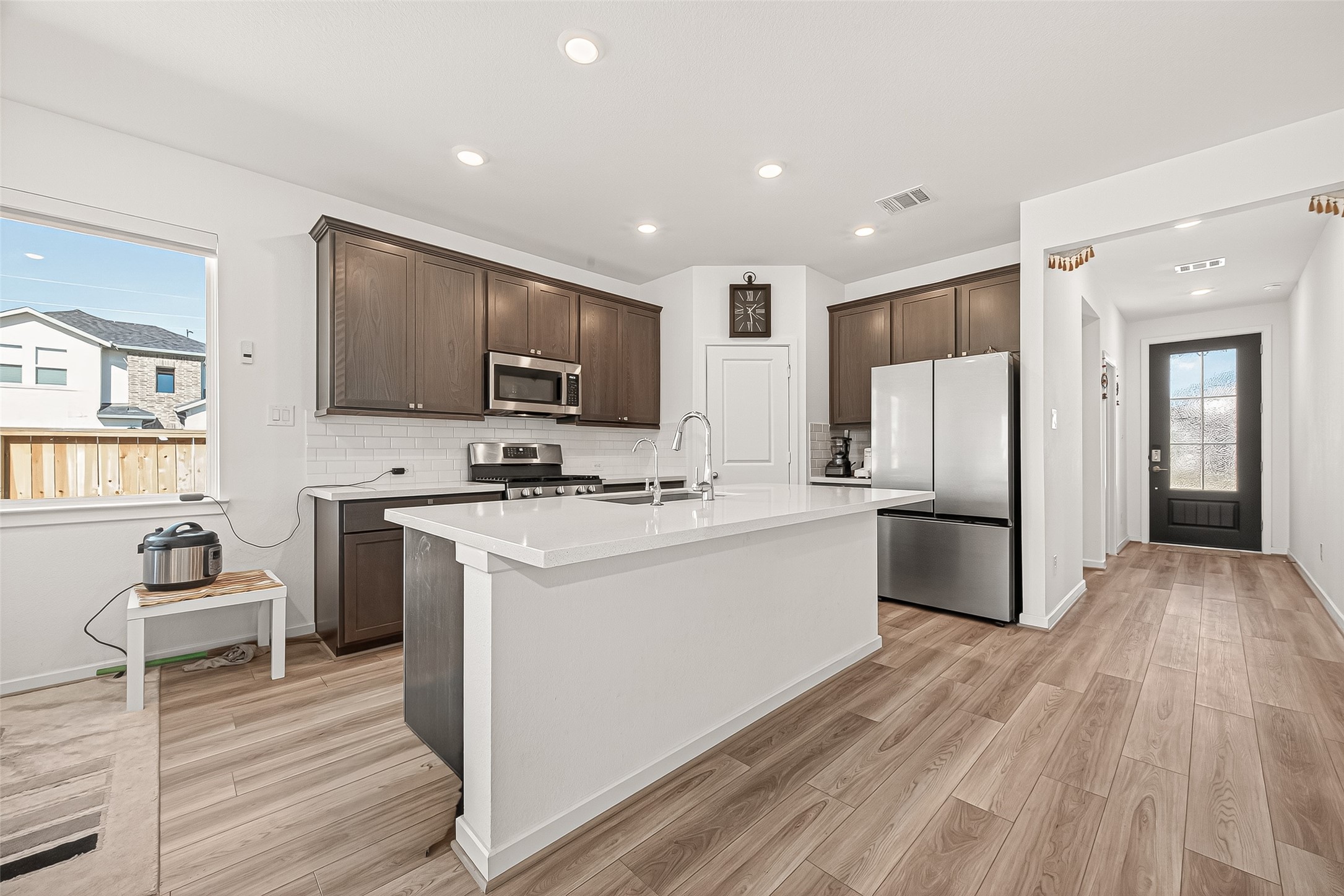 9747 Pettus Crk Drive Cypress, TX 77433 - Photo 18 of 48 a kitchen with stainless steel appliances granite countertop a refrigerator stove microwave and sink