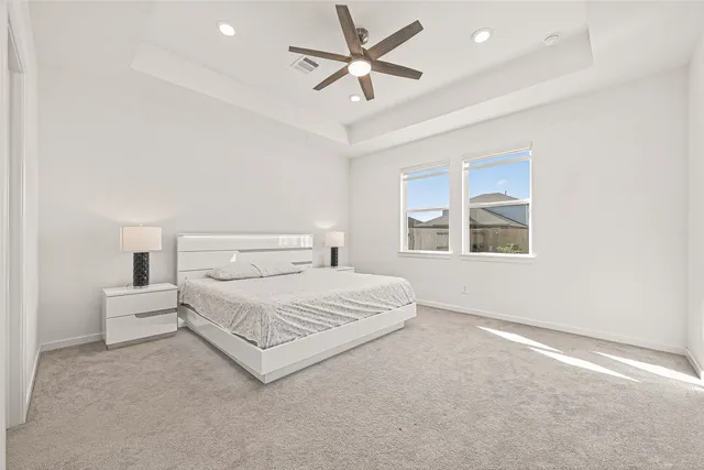 a spacious bedroom with a bed and a window