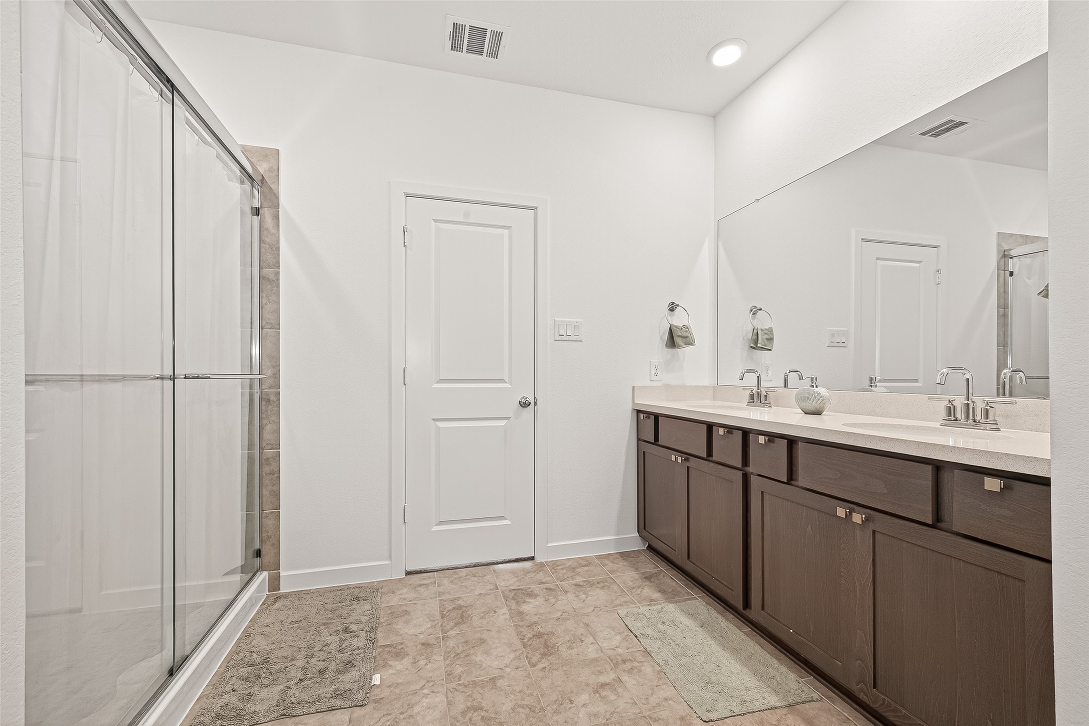 9747 Pettus Crk Drive Cypress, TX 77433 - Photo 26 of 48 a bathroom with a double vanity sink and mirror