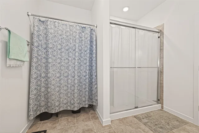 a bathroom with a shower and a curtain