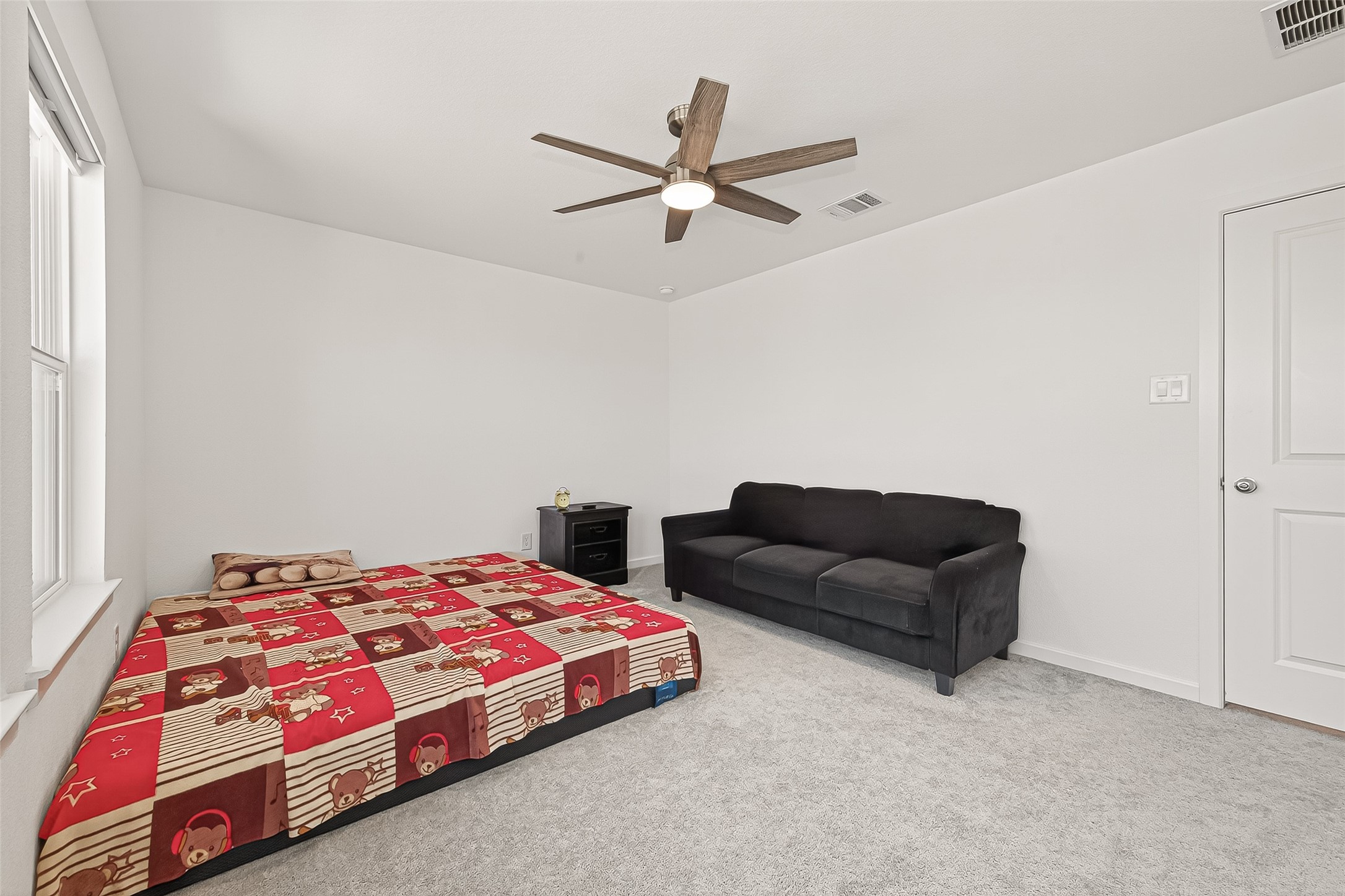 9747 Pettus Crk Drive Cypress, TX 77433 - Photo 36 of 48 a bedroom with a bed and a couch