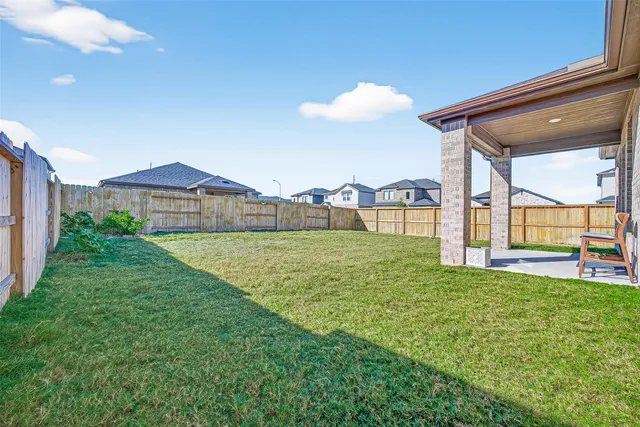 a view of a house with a backyard porch and furniture