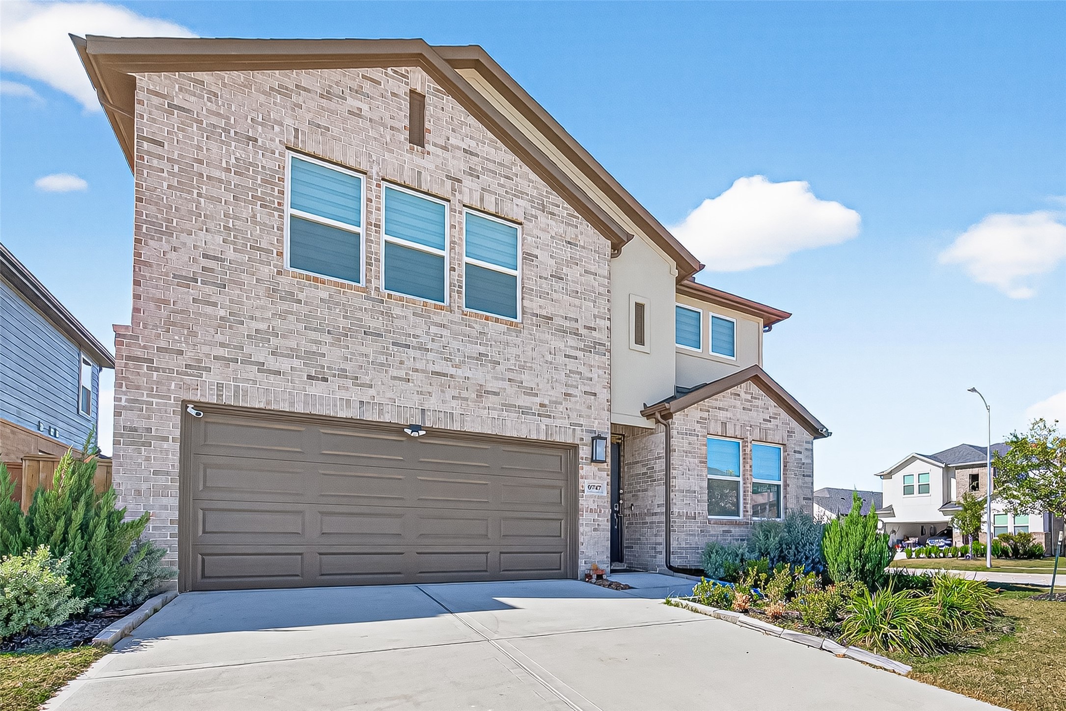 9747 Pettus Crk Drive Cypress, TX 77433 - Photo 5 of 48 a front view of a house with a yard and garage