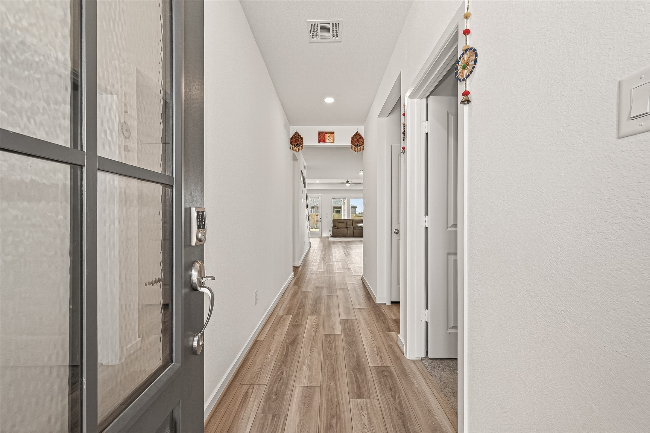 9747 Pettus Crk Drive Cypress, TX 77433 - Photo 7 of 48 a view of a hallway with wooden floor and staircase