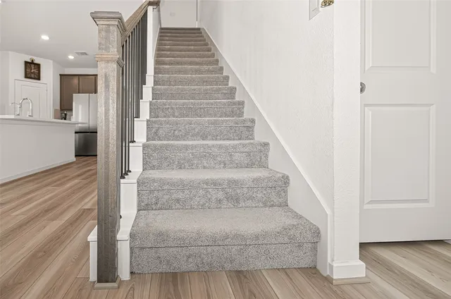 a view of staircase with white walls and stairs
