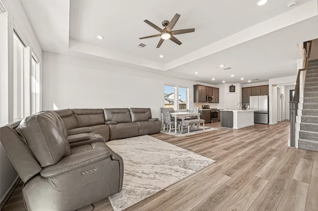 a living room with furniture and kitchen view