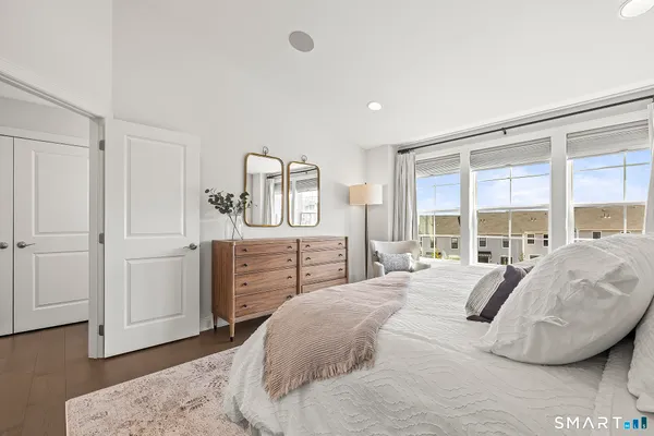 a bedroom with a bed and a large window