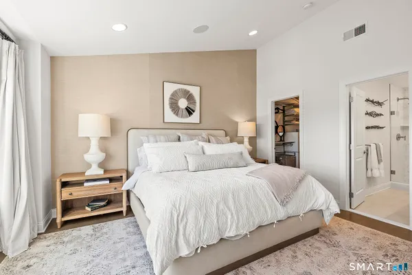a bedroom with a bed and a night stand