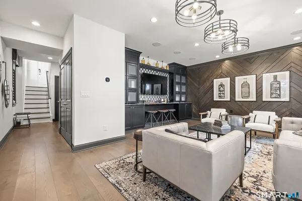 a living room with furniture and a chandelier