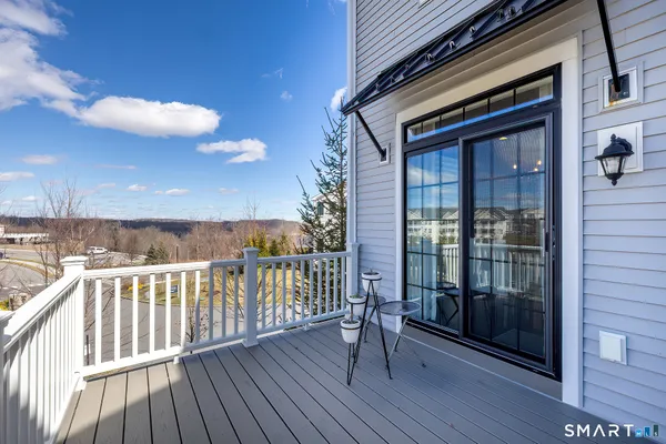 a view of a balcony with wooden floor