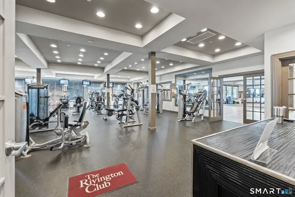 a gym room with lots of gym equipment