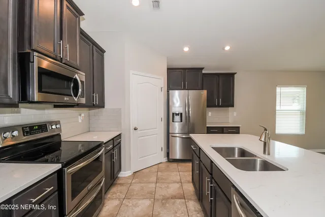 a kitchen with a sink stove and refrigerator