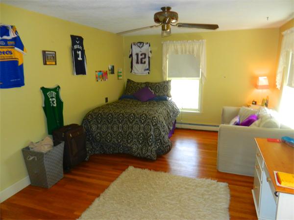 24 Herrick Road Boxford, MA 01921 - Photo 15 of 26 a bedroom with a bed and wooden floor