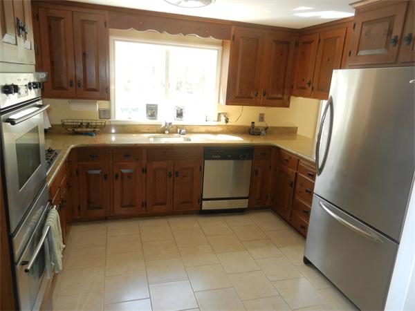 24 Herrick Road Boxford, MA 01921 - Photo 3 of 26 a kitchen with a refrigerator a stove a sink and a window