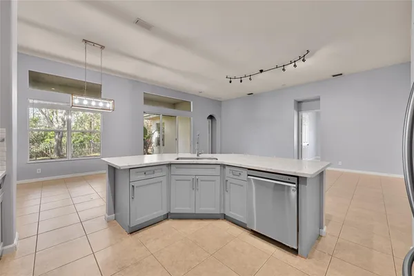 a spacious bathroom with a granite countertop sink and a mirror