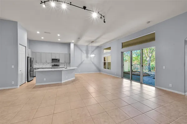 a large kitchen with stainless steel appliances a large counter top a stove a chimney a sink and cabinets